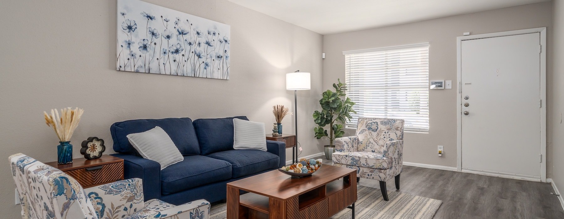 a living room with a blue couch and a coffee table