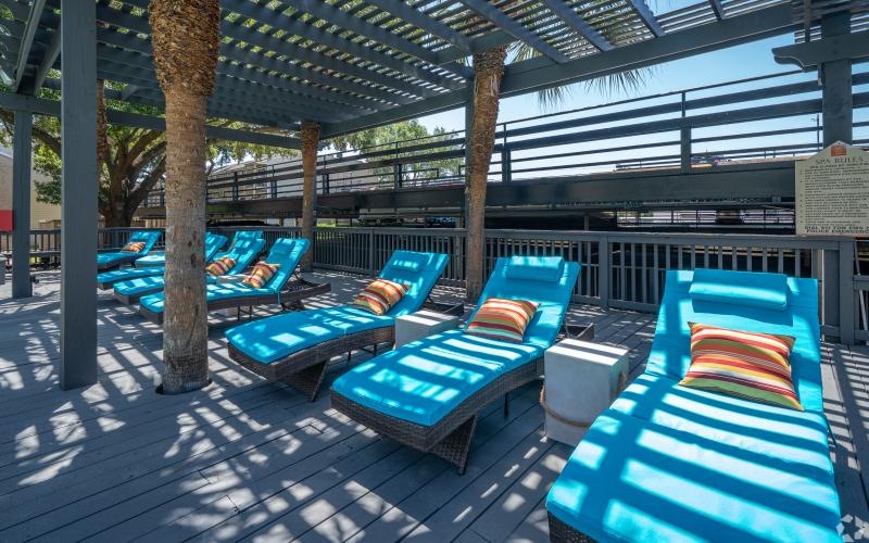 a group of lounge chairs on a deck