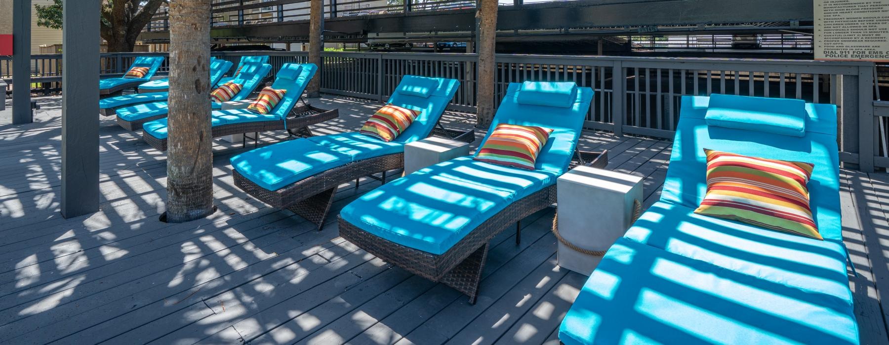 a group of lounge chairs on a deck