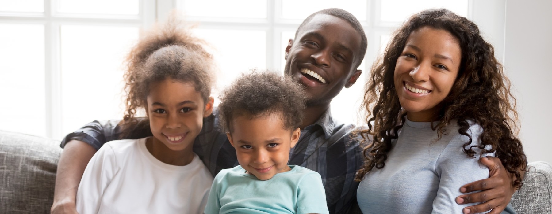 a family sitting on a couch